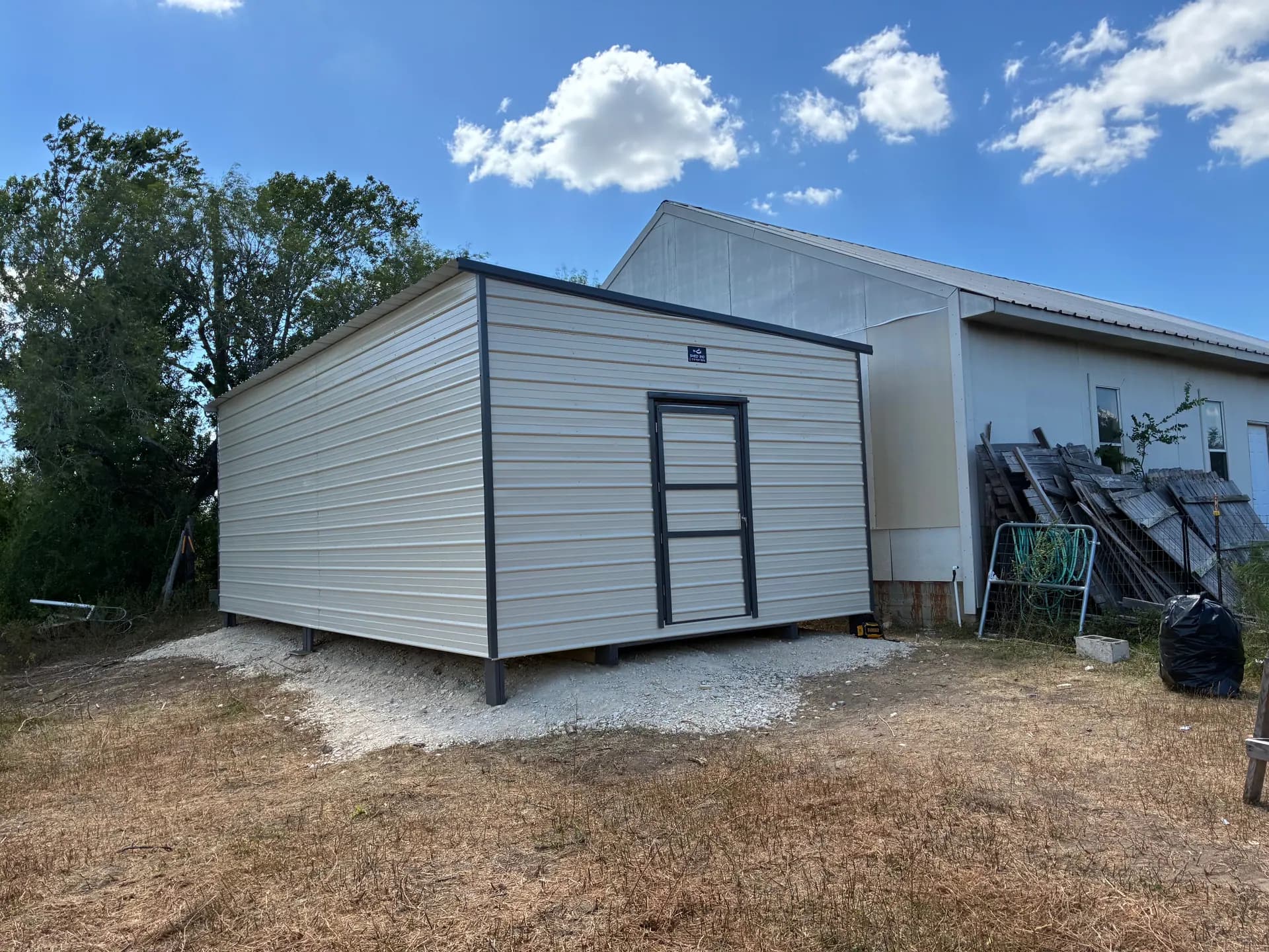Finished 15x30x10 slanted-roof game room building with light metal siding, dark trim, and a single door in San Antonio, TX.