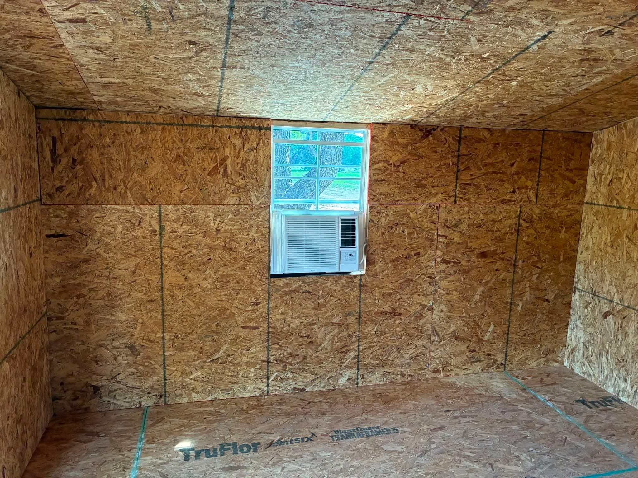 Interior of the 12x12 doghouse showing the window air conditioner