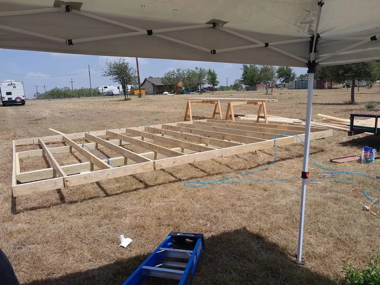 Raised wood floor frame for the 16x20 shed assembled on the Luling jobsite before the walls were built.