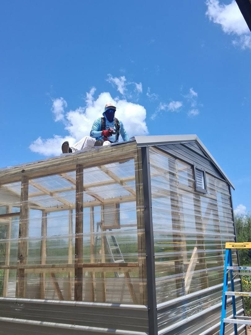 Shed210 installer completing the clear roof panels on the custom greenhouse