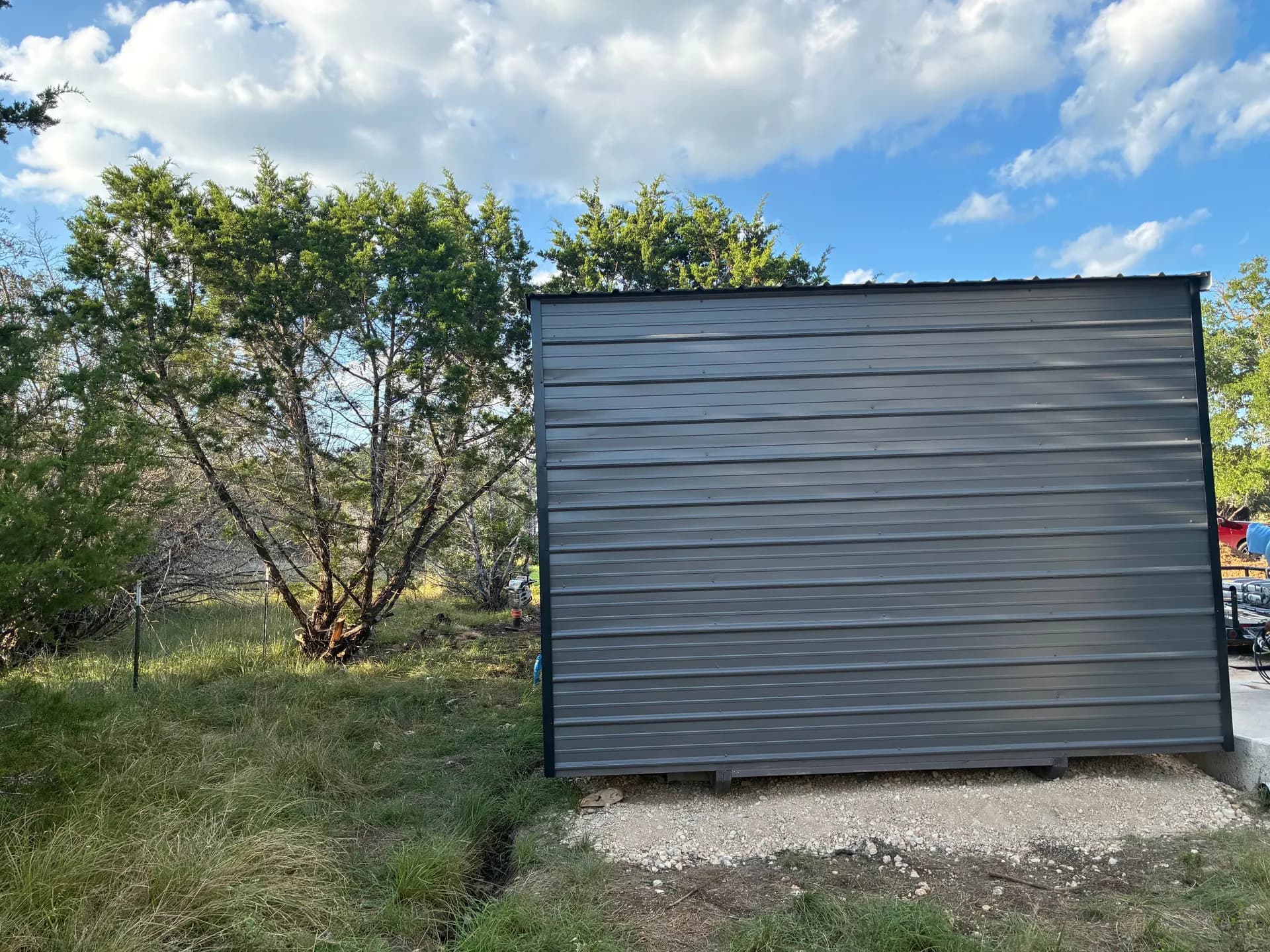 Side elevation of the Boerne utility shed showing the raised heavy-duty floor base on gravel
